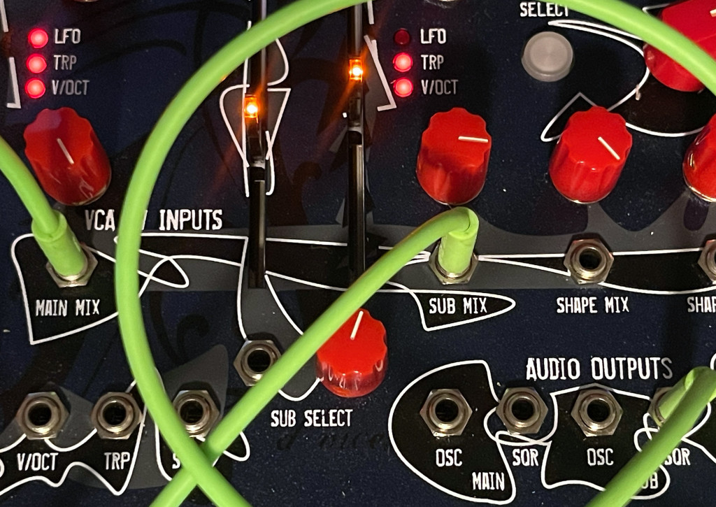 Close up of CV and VCA inputs and audio outputs, patched.