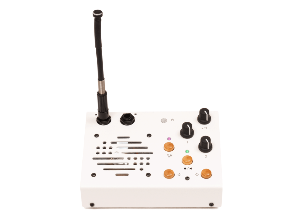 Portable recorder/looper on a white background. White with knobs and wooden buttons, a large speaker grill, and a gooseneck mic protruding perpendicular to the front panel.