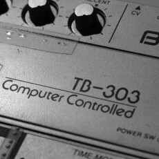 Close-p of vintage TB-303 hardware showing "Computer-Controlled" logo and knobs. "Old Roland TB-303" by Alexandre Dulaunoy is licensed under CC BY-SA 2.0.