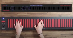 Still from Haken Continuum video with hands on the red-and-black horizontal ribbon controller of the Continuum Fingerboard; visualization above with Harmonic Resonator, circles overlaid on keyboard showing multi-dimensional expression.