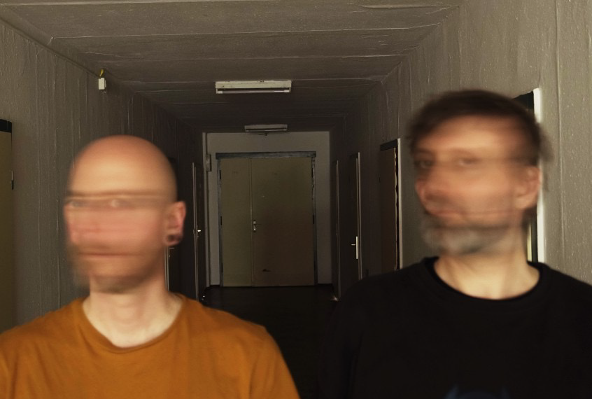 two men with blurred faces