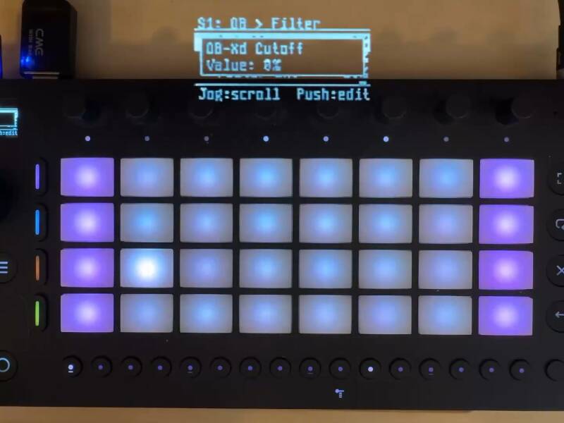 Ableton Move hardware, compact grid-based standalone groovebox, running Move Everything, showing overlay of (streamed) display wit OB-Xd open source Oberheim model and cutoff parameter